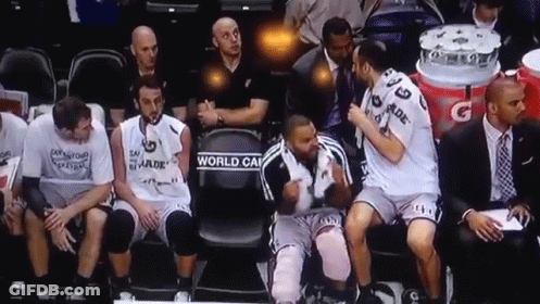 A Group Of Basketball Players Sitting On A Bench With One Wearing A Jersey That Says World Cup On It GIF