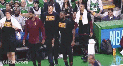 A Group Of Basketball Players Standing In Front Of A Crowd At A Basketball Game . GIF
