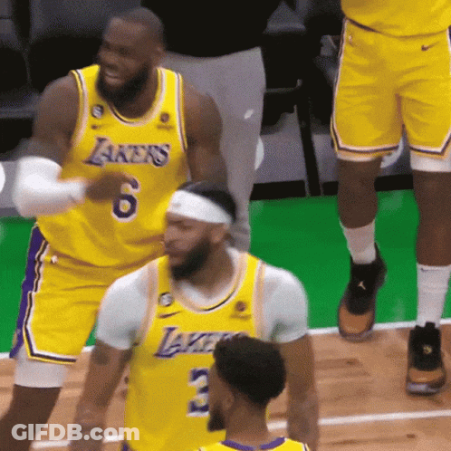 A Group Of Basketball Players Wearing Yellow Jerseys With Lakers On Them GIF