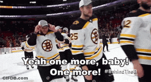 A Group Of Boston Bruins Hockey Players Are Standing On The Ice GIF