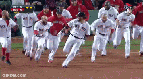 A Group Of Boston Red Sox Players Are Running On The Field GIF