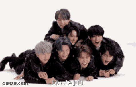 A Group Of Boys Are Laying On The Floor With The Words Bts De Juli Written On The Bottom . GIF