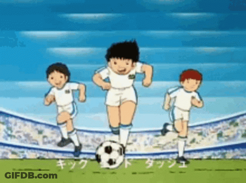 A Group Of Boys Are Playing Soccer On A Field With A Soccer Ball . GIF