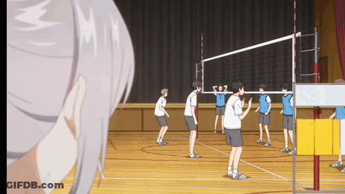 A Group Of Boys Are Playing Volleyball In A Gym GIF