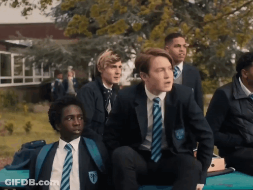 A Group Of Boys Are Sitting On A Bench And One Of Them Has The Letter F On His Uniform GIF