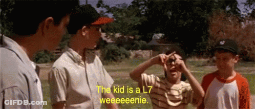 A Group Of Boys Are Standing In A Field And One Of Them Says The Kid Is A L7 Weeeeenie GIF