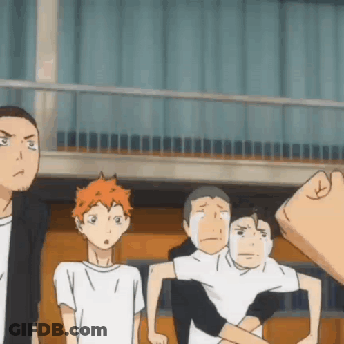 A Group Of Boys Are Standing Next To Each Other In A Room . GIF