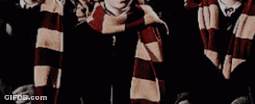 A Group Of Boys Wearing Scarves Are Standing Next To Each Other . GIF