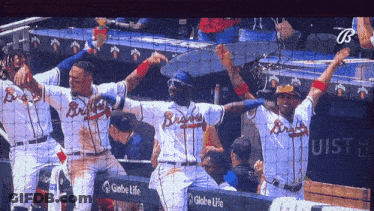 A Group Of Braves Baseball Players Celebrate Their Victory GIF
