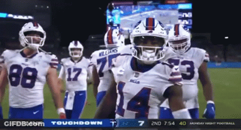 A Group Of Buffalo Bills Football Players Are Standing On The Field GIF
