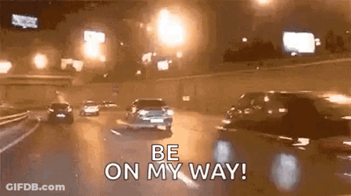 A Group Of Cars Are Driving Down A Highway At Night . GIF