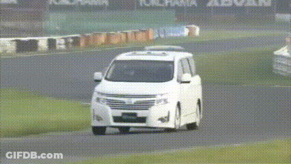 A Group Of Cars Are Driving On A Track With Yokohama Advan Written On The Wall GIF