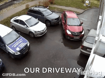 A Group Of Cars Are Parked In A Driveway With The Caption " Our Driveway Viral Hog " GIF