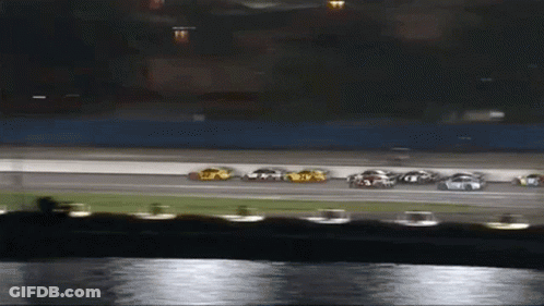 A Group Of Cars Are Racing On A Race Track GIF