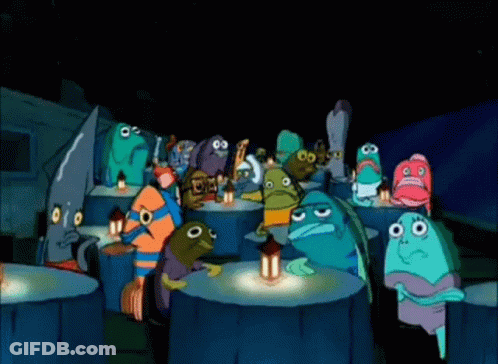 A Group Of Cartoon Characters Are Sitting Around A Table With A Lantern . GIF