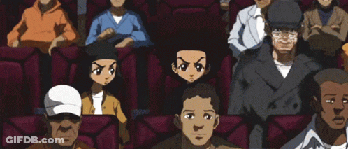 A Group Of Cartoon Characters Are Sitting In A Theatre GIF