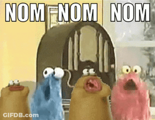 A Group Of Cartoon Characters Are Standing In Front Of A Radio With The Words Nom Nom Nom Written On It GIF