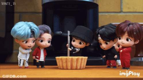 A Group Of Cartoon Characters Standing Around A Cupcake On A Table With Imgplay Written In The Corner GIF