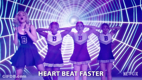 A Group Of Cheerleaders Are Dancing In Front Of A Spider Web And The Words Heart Beat Faster Are On The Screen GIF