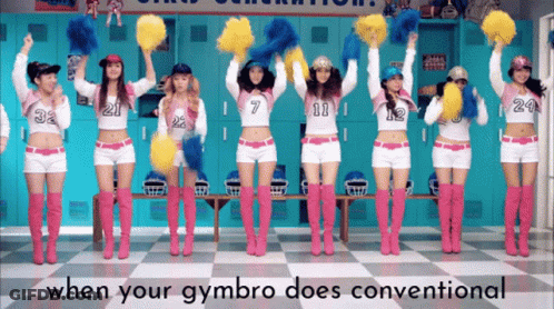 A Group Of Cheerleaders Are Holding Up Pom Poms In Front Of Lockers GIF
