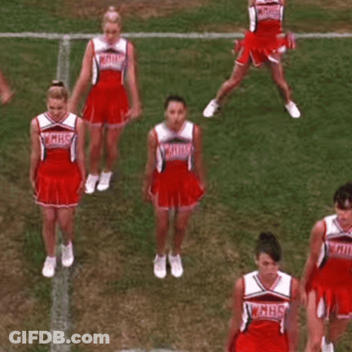 A Group Of Cheerleaders Are Performing A Dance On A Field . GIF