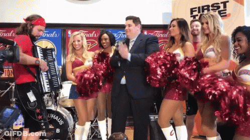 A Group Of Cheerleaders Are Standing In Front Of A Drum That Says Bauhaus GIF