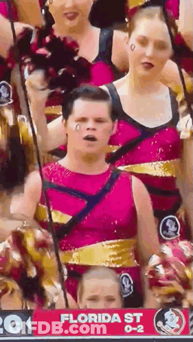 A Group Of Cheerleaders Are Standing In Front Of A Florida St Sign . GIF