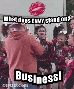 A Group Of Cheerleaders Are Standing In Front Of A Sign That Says Envy Stand On Business GIF