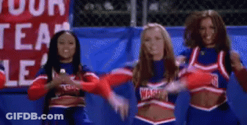 A Group Of Cheerleaders Are Standing Next To Each Other In Front Of A Sign That Says Warriors . GIF