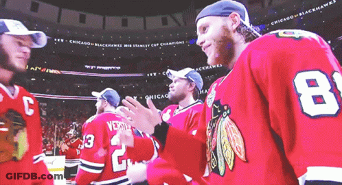 A Group Of Chicago Blackhawks Players Standing Together GIF