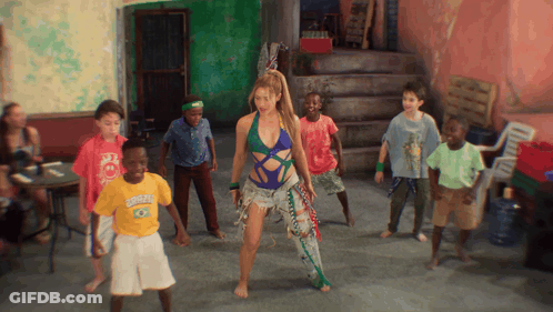 A Group Of Children Are Dancing In A Room And One Of Them Is Wearing A Shirt That Says Rio De Janeiro GIF
