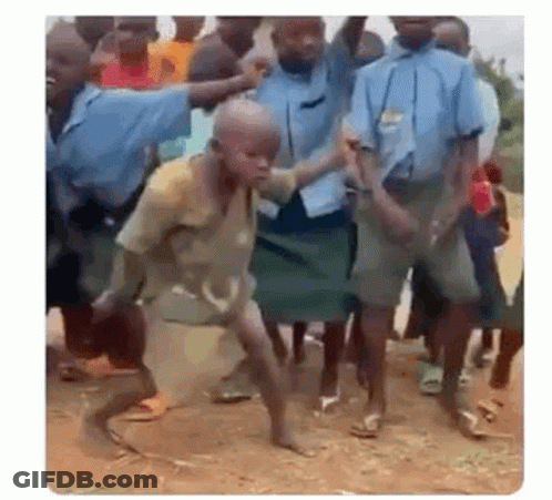 A Group Of Children Are Dancing In The Dirt In Front Of A Crowd . GIF