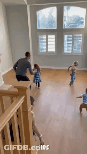 A Group Of Children Are Playing In A Living Room . GIF
