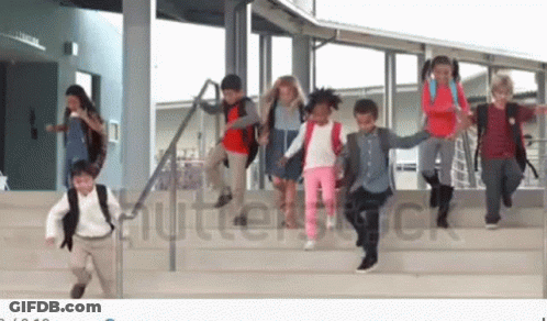 A Group Of Children Are Running Down The Stairs Of A School Building Holding Hands . GIF