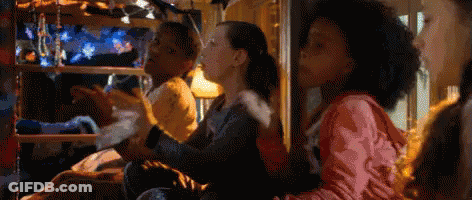 A Group Of Children Are Sitting In A Bunk Bed Playing A Video Game . GIF