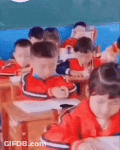 A Group Of Children Are Sitting In A Classroom . GIF