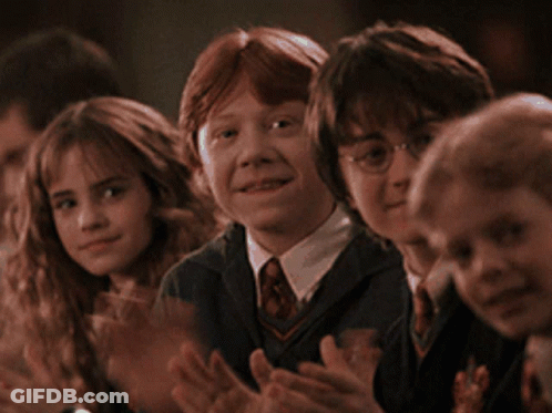 A Group Of Children Are Sitting In A Row Clapping GIF