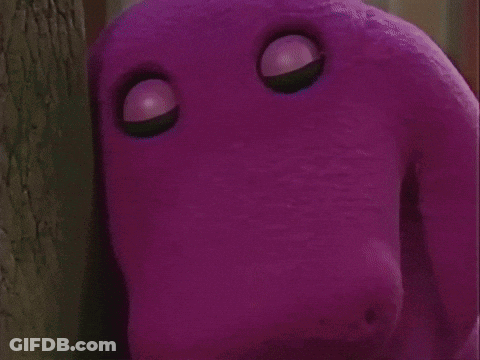 A Group Of Children Are Standing Around A Purple Stuffed Animal . GIF