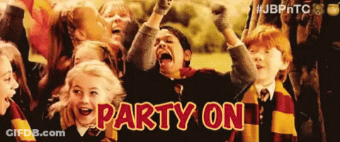 A Group Of Children Are Standing In A Field With Their Arms In The Air . GIF