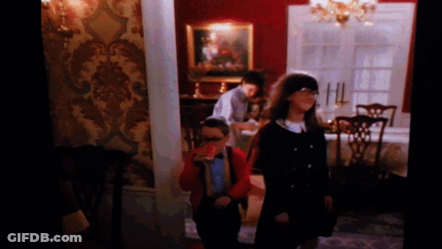 A Group Of Children Are Standing In A Room GIF