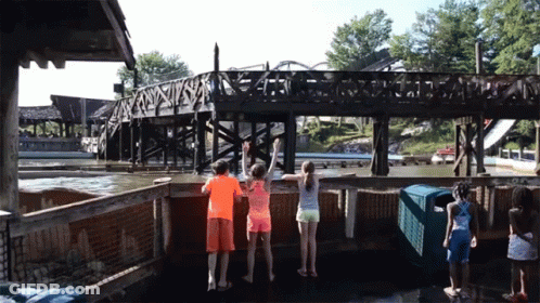 A Group Of Children Are Standing In Front Of A Bridge That Says ' A ' On It GIF