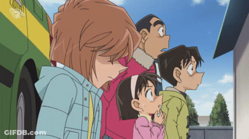 A Group Of Children Are Standing In Front Of A Green And Yellow Vehicle GIF