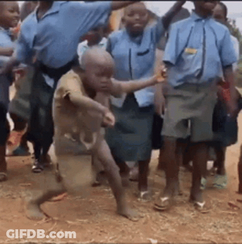A Group Of Children In School Uniforms Are Dancing On The Ground GIF