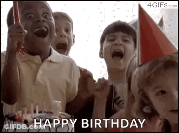 A Group Of Children Wearing Party Hats Are Celebrating A Birthday With A Cake And Candles . GIF
