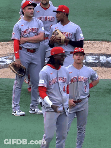 A Group Of Cincinnati Baseball Players Stand On A Field GIF