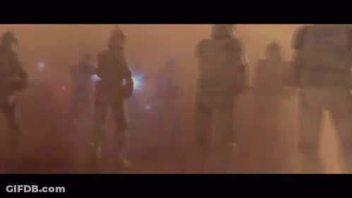 A Group Of Clone Troopers Are Walking Through A Foggy Field GIF