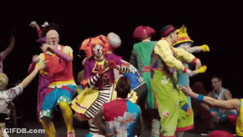 A Group Of Clowns Are Dancing Together On Stage GIF