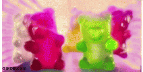 A Group Of Colorful Gummy Bears On A Table GIF