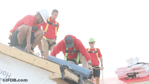A Group Of Construction Workers Are Working On A Roof And One Of Them Is Wearing A Red Shirt With The Letter A On The Fr GIF