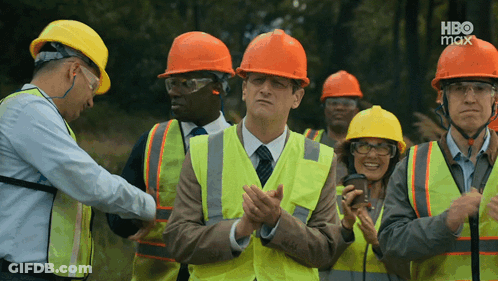 A Group Of Construction Workers Wearing Hard Hats And Safety Vests With Hbo Max In The Corner GIF